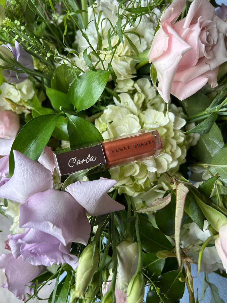 Toronto calligrapher engraver Jessie Wang engrave on Fenty gloss bomb lip glosses for a Toronto bridal shower event
