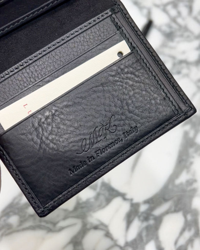 Black leather wallet featuring blind debossed initials created by JW Lettering in Toronto at Luca Faloni Store Launch, showing tone-on-tone personalization without foil.