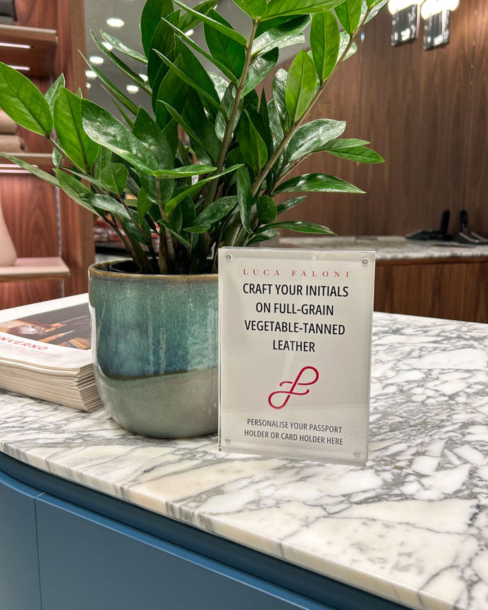 In-store personalization setup at Luca Faloni Toronto, featuring JW Lettering’s live heat foiling station for leather goods.