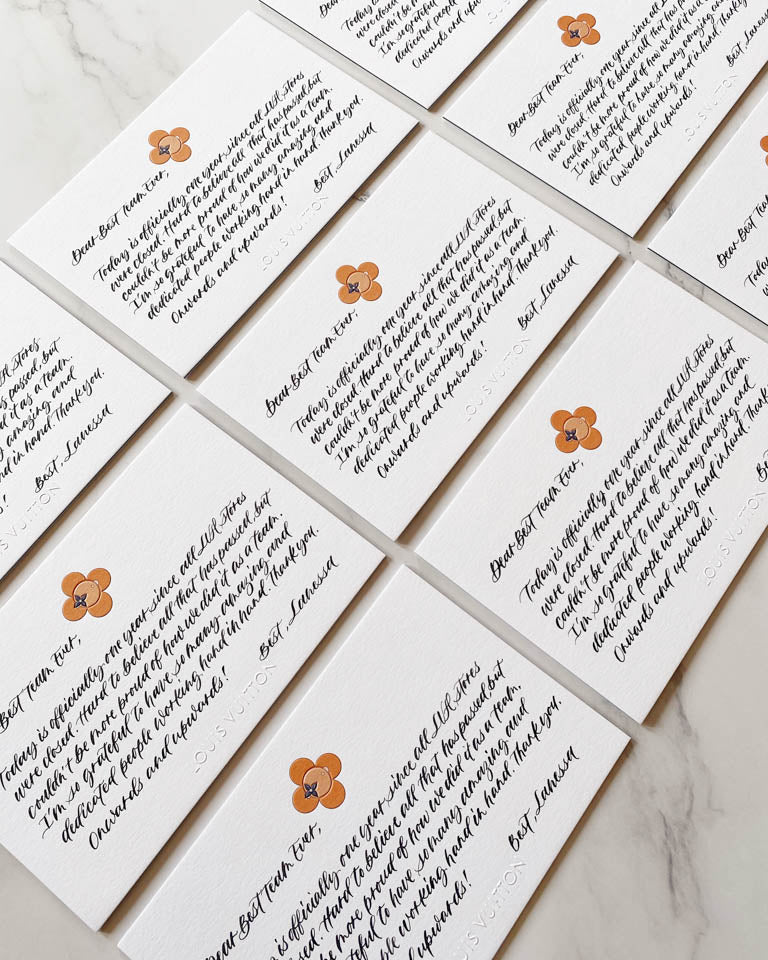 Set of Louis Vuitton branded cards featuring elegant black ink calligraphy notes with orange floral motifs, handwritten for a luxury brand event in Toronto by JW Lettering calligrapher Jessie Wang.