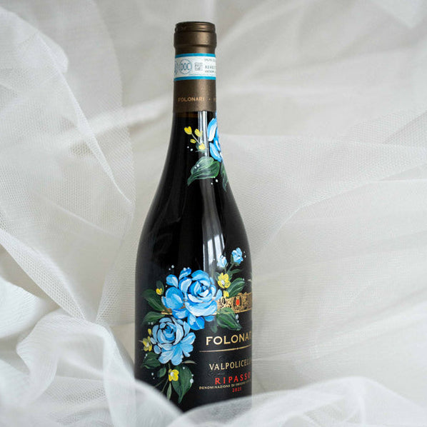 Luxury hand-painted wine bottle featuring blue florals by Toronto live artist Jessie Wang.