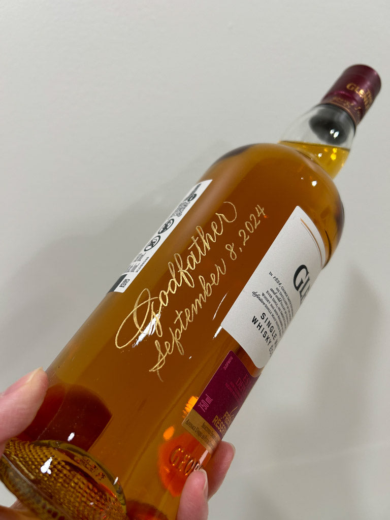 Luxurious gold engraved whisky bottle personalized as a Toronto baptism gift.