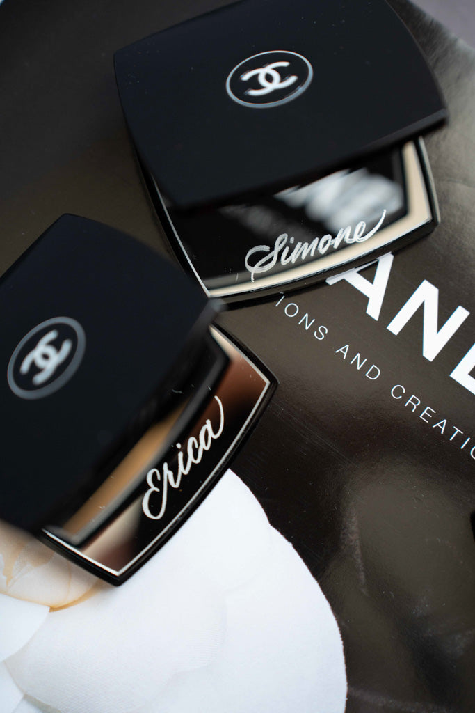 Custom engraved Chanel makeup compacts personalized with names by Toronto engraving artist.