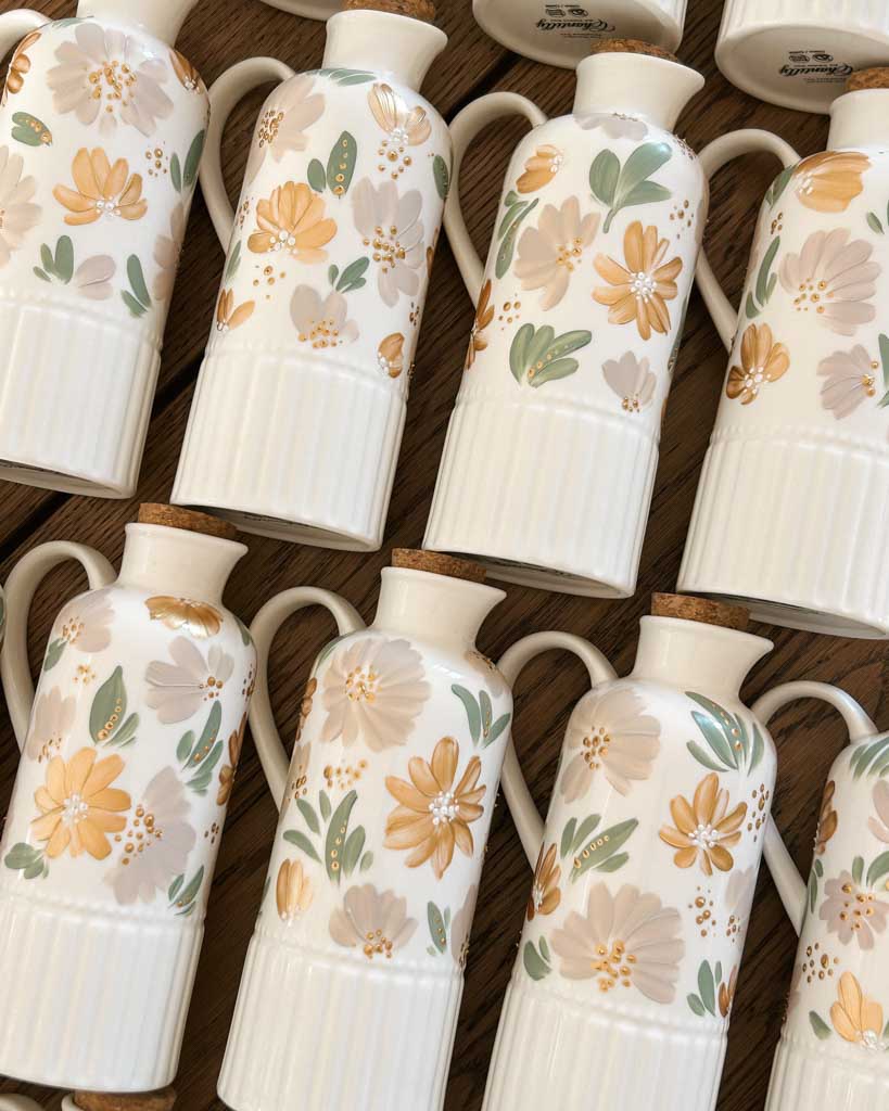 Gold, taupe floral hand-painted ceramic bottles created as custom wedding favors in Toronto.