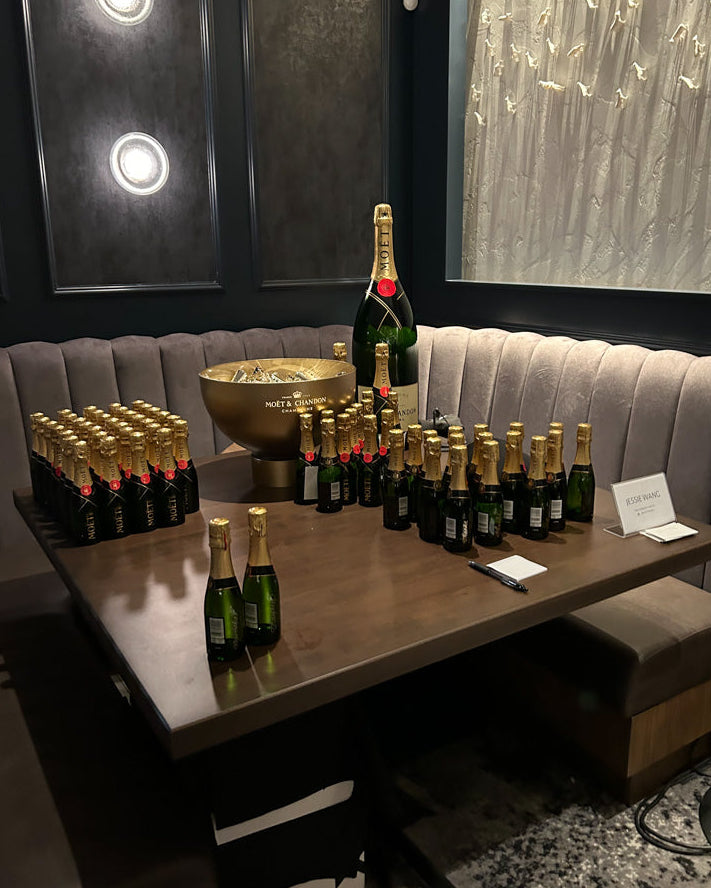 Toronto calligrapher Jessie Wang preparing Moët & Chandon mini bottles for live engraving brand activation event.