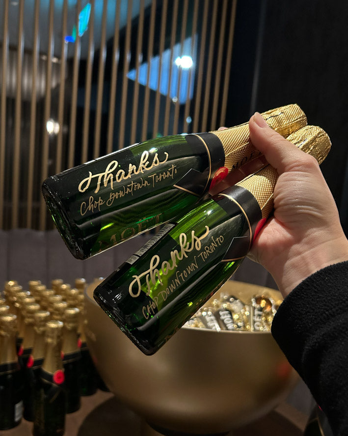 Personalized Moët mini bottles engraved with gold calligraphy for corporate brand activation restaurant opening for Chop Streakhouse in Toronto.