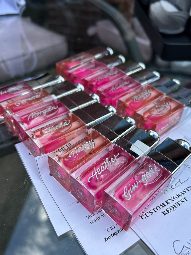 Custom engraved Dior lip glosses with guest names created live during Toronto wedding event.